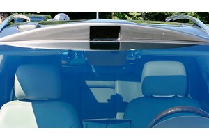 An Infrared sensor is seen above the windshield and two cameras are also seen beside the rear-view mirror of this Cadillac SRX that was modified by Carnegie Mellon University parked in a lot in.